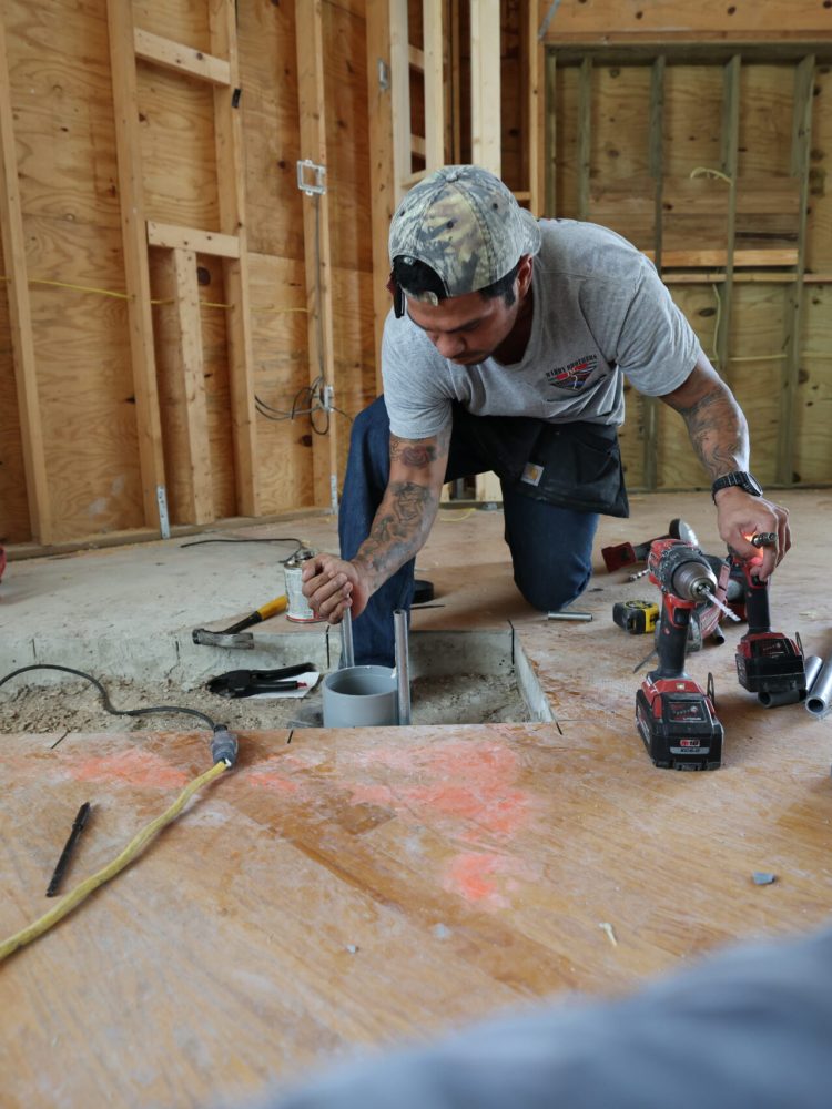 Mabry Brothers Employee conducting Electrical Work In Floor